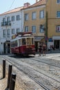 Typical Yellow Vintage Tram in Narrow Street of Lisbon, Portugal Royalty Free Stock Photo