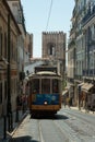 Typical Yellow Vintage Tram in Narrow Street of Lisbon, Portugal Royalty Free Stock Photo