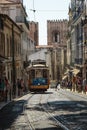 Typical Yellow Vintage Tram in Narrow Street of Lisbon, Portugal. Royalty Free Stock Photo