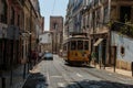 Typical Yellow Vintage Tram in Narrow Street of Lisbon, Portugal