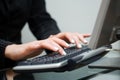 Woman typing on computer keyboard