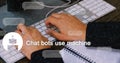 Typing on keyboard, person developing chatbot software with notebook on desk Royalty Free Stock Photo