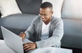 Typing, man and remote work with laptop in home office on sofa with online research for writing project. Email Royalty Free Stock Photo