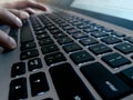 Typing on silver and black laptop keyboard Royalty Free Stock Photo