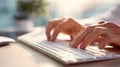 Typing on white computer keyboard with natural light and blurred background creating calm and focused atmosphere Royalty Free Stock Photo