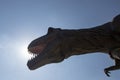 Tyrannosaurus rex animatronic replica photographed from below against the sun Royalty Free Stock Photo
