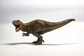 Scary plastic childrens toys T-rex on white background