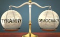 Tyranny and democracy staying in balance - pictured as a metal scale with weights and labels tyranny and democracy to symbolize