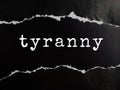 tyranny text title on black torn paper background Royalty Free Stock Photo