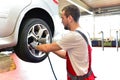 Tyre change on the car in a workshop by a mechanic Royalty Free Stock Photo