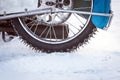 Tyre of motocross bike on ice and snow on background,