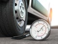 Tyre pressure gauge and car wheel. Inflation, inspection and measurement of wheel tyre Royalty Free Stock Photo