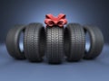 Tyre with a red ribbon. Gift. 3D Icon on blue