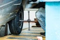 Tyre repairman adjusting the screws of a a wheel on a car in Galle, Sri Lanka