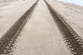 Tyre or tire tracks on the sand beach. Kamchatka, Russia. Close up image Royalty Free Stock Photo