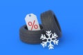 Tyres near snowflake and label with percent symbol. Special offer