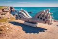 Tyulenovo, Bulgaria - 16.04.2021. Wooden bench in the shape of sea waves on the shore of popular tourist destination - Tyulenovo