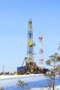 Industrial winter landscape with a drilling rig in the North of Western Siberia