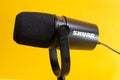 Tyumen, Russia-April 09, 2022: Professional microphone Shure mv 7. On a yellow background
