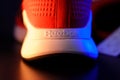 Tyumen, Russia-August 03, 2023: Reebok logo mens model Nanoflex in the red, blue light. Selective focus