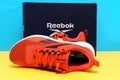 Tyumen, Russia-August 03, 2023: Reebok sneakers mens model Nanoflex TR V2. Yellow and blue background