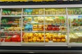 Tyumen, Russia-December 11, 2023: Interior view of the huge open refrigerator with various brands local cheese on the