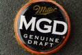 Tyumen, Russia-February 15, 2023: MGD logo retro cap on bottle close up. Miller Genuine Draft is the original draft beer