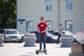 Tyumen, Russia, on July 15, 2018: the teenage boy rides a giroskuter in the summer on the square Royalty Free Stock Photo