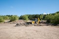 Tyumen, Russia, July 6, 2021: tractor, excavator, bulldozer stuck in sand and clay on the shore