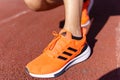 Tyumen, Russia-June 15, 2022: Running orange sneakers adidas, Adidas, a multinational company. Model EQ21