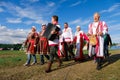 Tyumen, Russia-June 15, 2019. Women And Men In Traditional Costumes Sing With Different Emotions, Play Musical Instruments, At An