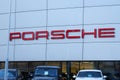 Tyumen, Russia-March 18, 2024: Cars parked in rows in front of a Porsche dealership, showcasing various models and