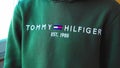 Tyumen, Russia-March 02, 2024: Person is wearing a green Tommy Hilfiger sweatshirt. Selective focus