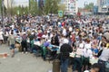 Tyumen, Russia, on May 9, 2019: The field kitchen on the square. People taste soldier`s porridge during the holiday Victory Day
