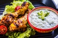 Tzatziki sauce. Tzatziki dressing. Tzatziki dressing with grilled chicken legs and fresh vegetable,lettuce leaf and cherry Royalty Free Stock Photo