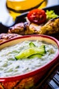 Tzatziki sauce. Tzatziki dressing. Tzatziki dressing with grilled chicken legs and fresh vegetable,lettuce leaf and cherry Royalty Free Stock Photo