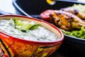 Tzatziki sauce. Tzatziki dressing. Tzatziki dressing with grilled chicken legs and fresh vegetable,lettuce leaf and cherry Royalty Free Stock Photo