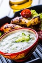 Tzatziki sauce. Tzatziki dressing. Tzatziki dressing with grilled chicken legs and fresh vegetable,lettuce leaf and cherry Royalty Free Stock Photo