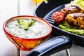 Tzatziki sauce. Tzatziki dressing. Tzatziki dressing with grilled chicken legs and fresh vegetable,lettuce leaf and cherry Royalty Free Stock Photo