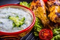 Tzatziki sauce. Tzatziki dressing. Tzatziki dressing with grilled chicken legs and fresh vegetable,lettuce leaf and cherry Royalty Free Stock Photo