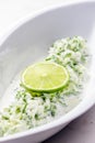 tzaziki salad with lime in white bowl