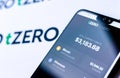 TZero logos on the brochure and the smartphone with the tZERO Crypto App screenshot. Editorial photo illustrative for news on a ne