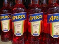 Close up of isolated red Aperol liquor bottles in shelf of german supermarket Royalty Free Stock Photo