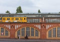 An U-bahn metro train passing on a viaduct in the Friedrichshain district, Berlin, Germany.