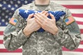 U.S. Army soldier holding folded USA flag before his chest Royalty Free Stock Photo