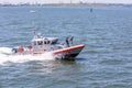 A U.S. Coast Guard boat patrols the in New York Harbor by the Statue of Liberty.