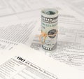 1041 U.S. Income tax return for Estates and Trusts form with roll of american dollar banknotes