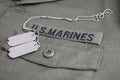 U.S. MARINES Branch Tape with dog tags on olive drab uniform