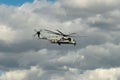 U.S. navy marines helicopter flying through the sky on a cloudy day