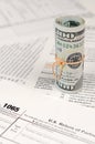 1065 U.S. Return of Parentship Income form with roll of american dollar banknotes